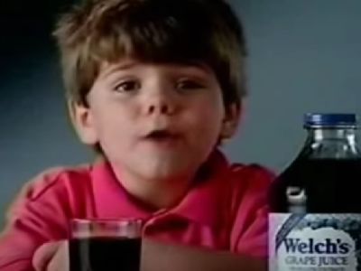 Travis Tedford has Welch's Grape Juice bottle and a glass in front of him.